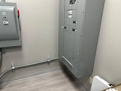 The distribution wall of the imaging suite: main distribution panel, safety switches and transformer set on one line, conduit dressed to a common height.