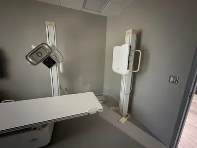 A radiographic wall stand with its feed conduit run down the wall and terminated at the unit.